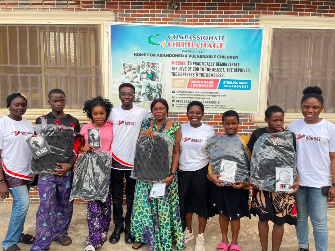 Children holding school bags and books presented by The August Mandate team